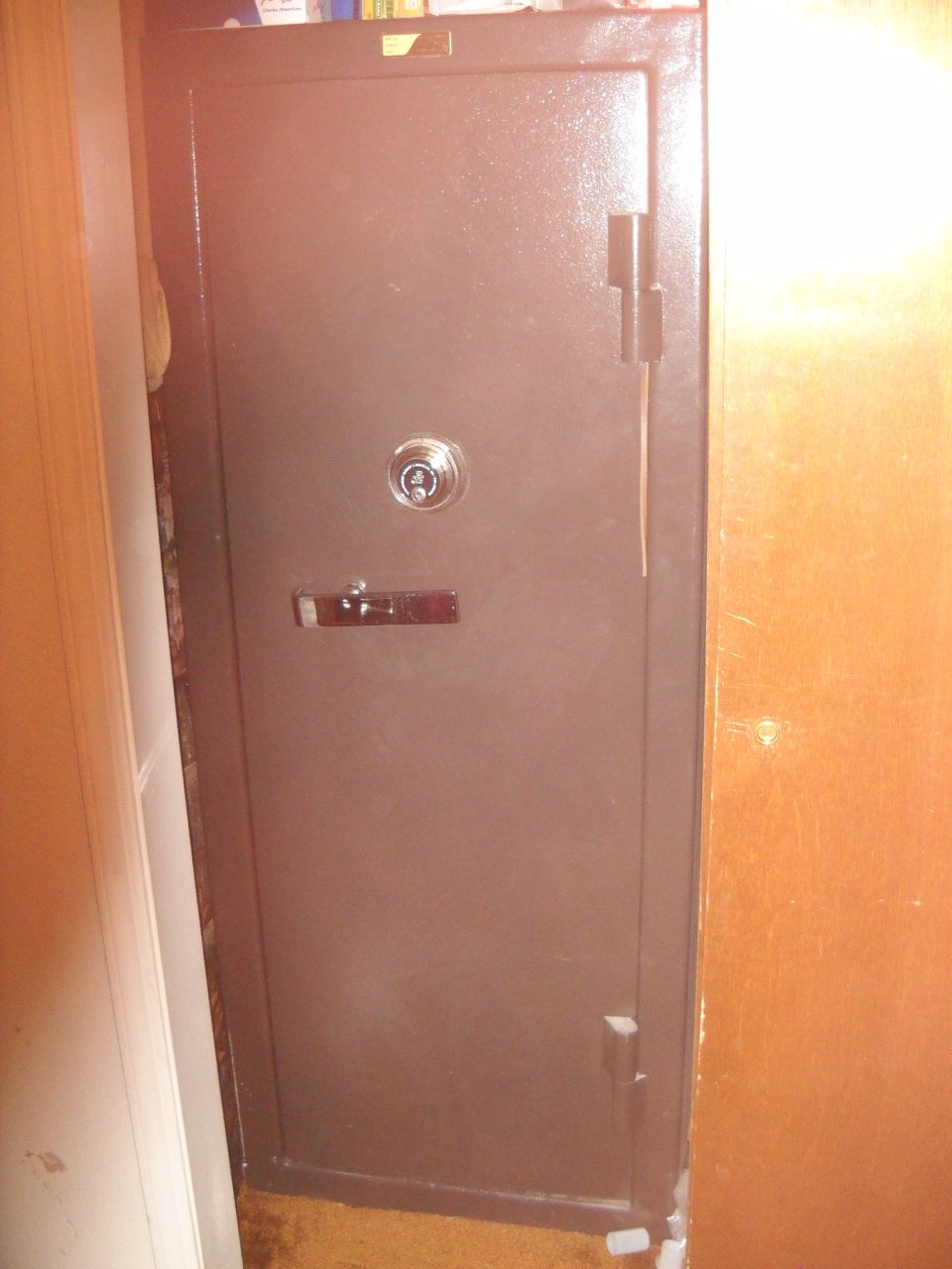 Brown metal safe with a combination lock and handle