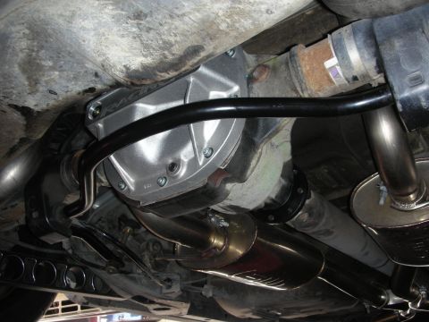 2004 Ford Crown Victoria - Close-up of the rear differential and exhaust system, likely an aftermarket upgrade.