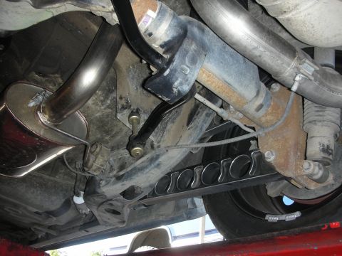2004 Ford Crown Victoria - Underside view of a vehicle's rear suspension and exhaust system, custom trailing arms.