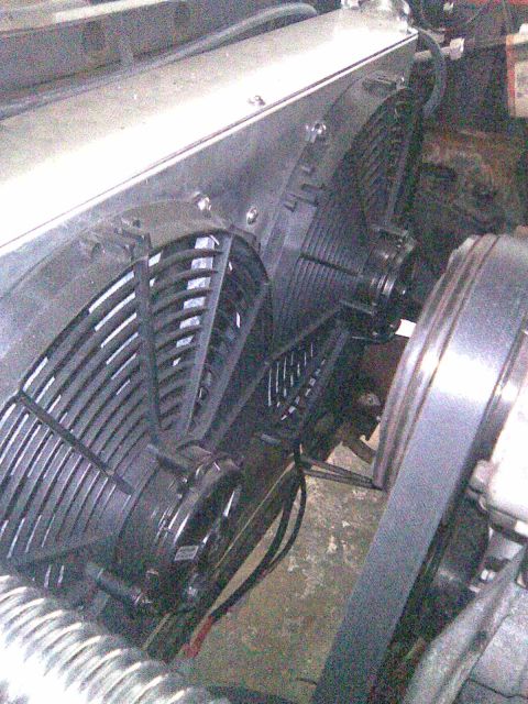 1991 Ford Bronco - Close-up view of radiator fans and serpentine belt assembly.