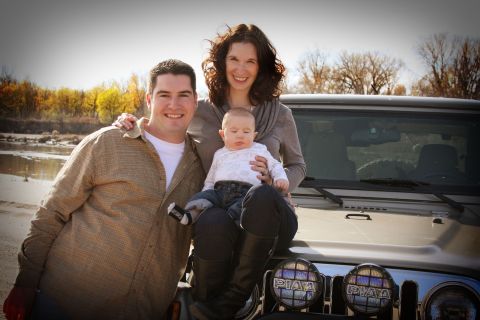 2005 Jeep Wrangler - A family poses on the hood of a 2005 Jeep Wrangler, PIAA lights and a riverbed in the background.