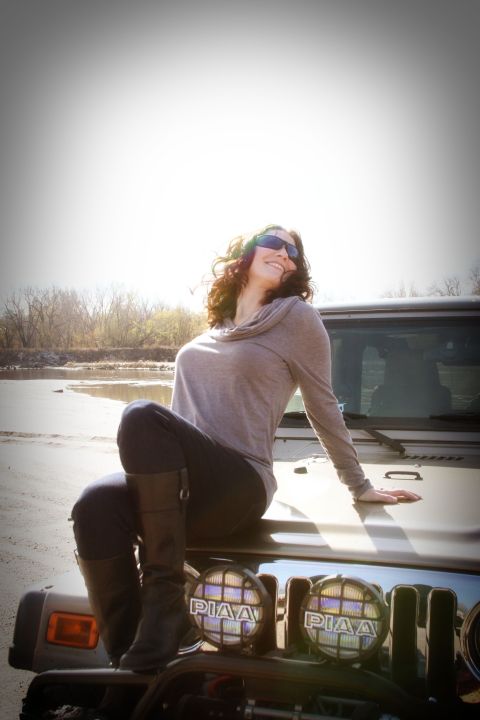 2005 Jeep Wrangler - A woman poses on the hood of a Jeep Wrangler near a body of water on a sunny day.