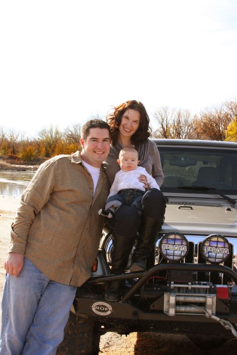 2005 Jeep Wrangler - A family poses on the hood of a silver Jeep Wrangler with an aftermarket bumper and winch.