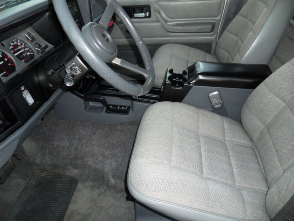 1994 Jeep Cherokee interior showing front seats, dashboard, steering wheel, and center console