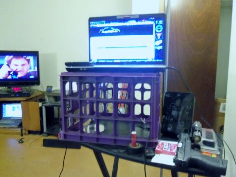 2000 Mercury Grand Marquis - A laptop screen displays a car silhouette and a bar graph, placed on a purple crate.