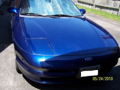 1993 Ford Probe - Front view of a blue 1993 Ford Probe, its distinctive pop-up headlights in the down position.