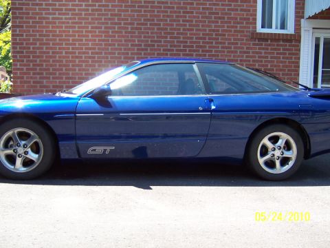 1993 Ford Probe - 1993 Ford Probe GT seen from the side, parked outside a brick house.