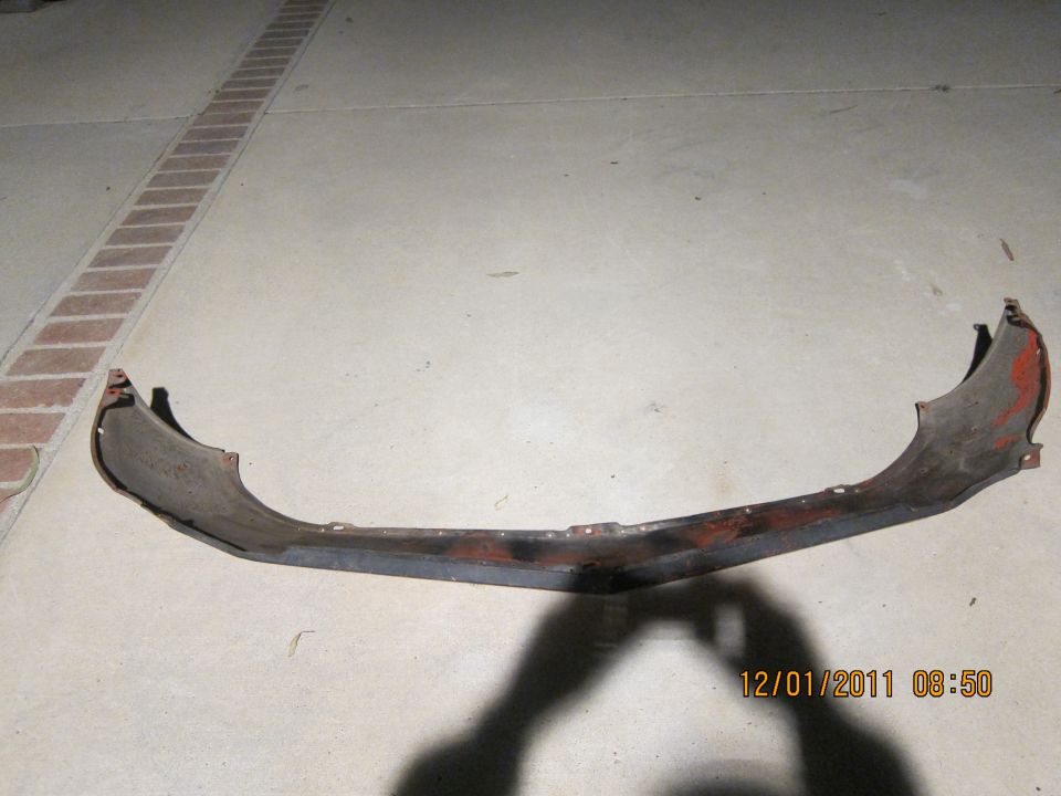worn car bumper with red paint visible on edges