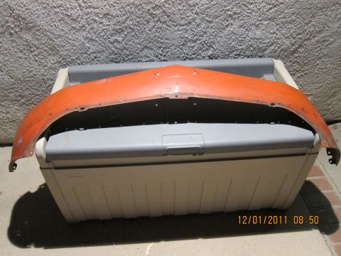 1969 Ford Mustang - An orange car fender rests on a cooler against a textured wall, with a date stamp visible in the corner.
