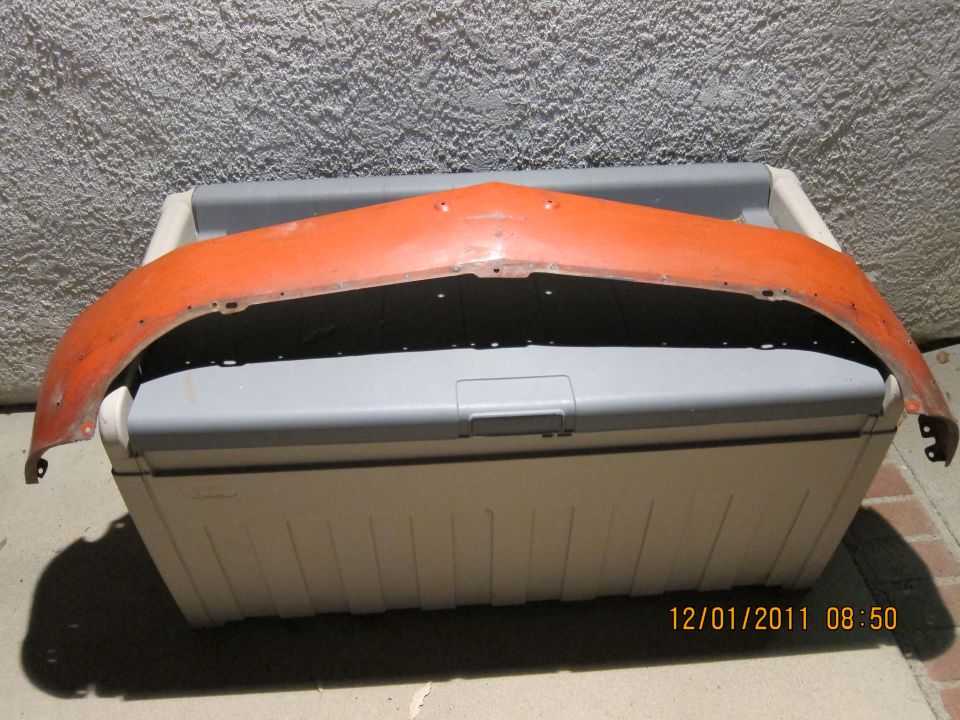 Orange car fender sitting on a cooler. Date stamp 12/01/2011