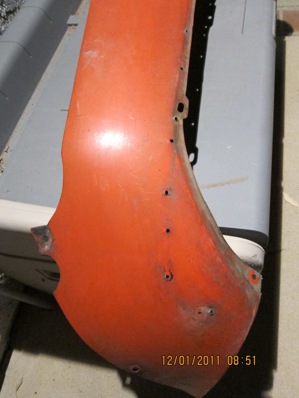 Orange fender part with mounting holes