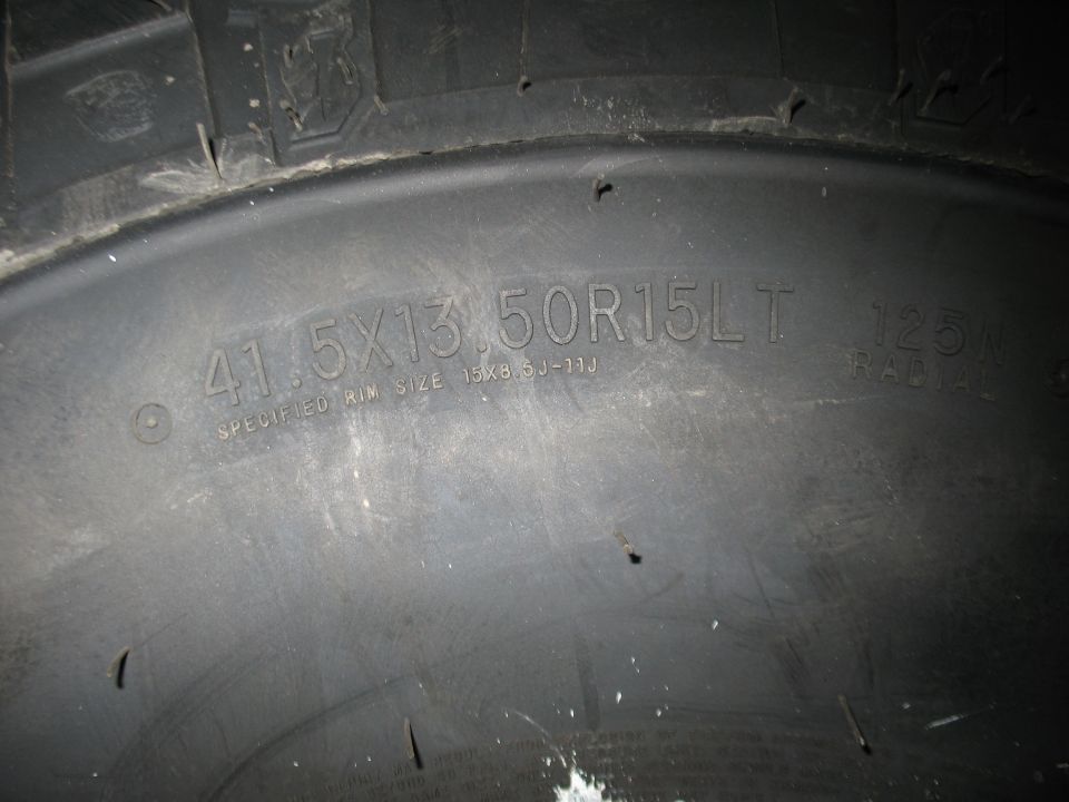 Close-up of tire sidewall reading 41.5X13.50R15LT