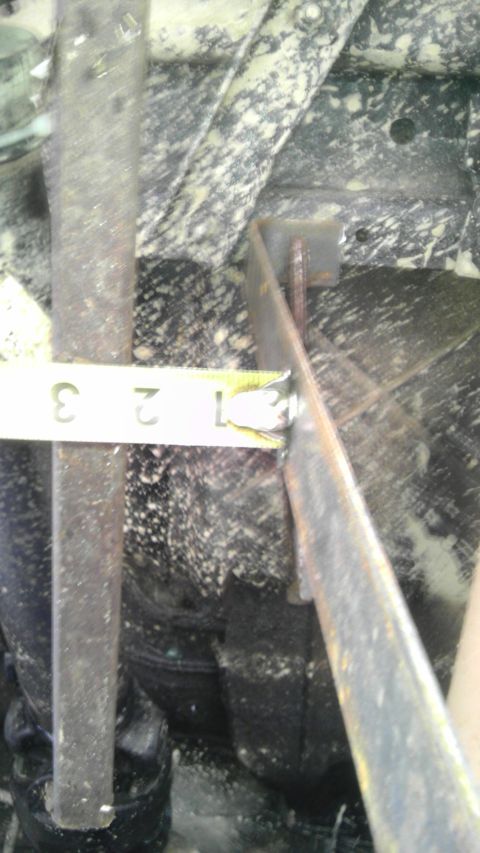 1989 Ford Bronco - Measuring a suspension component with a tape measure. The measurement is between 1 and 3 inches.