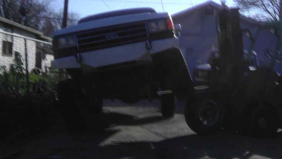 1989 Ford Bronco front view, lifted by forklift