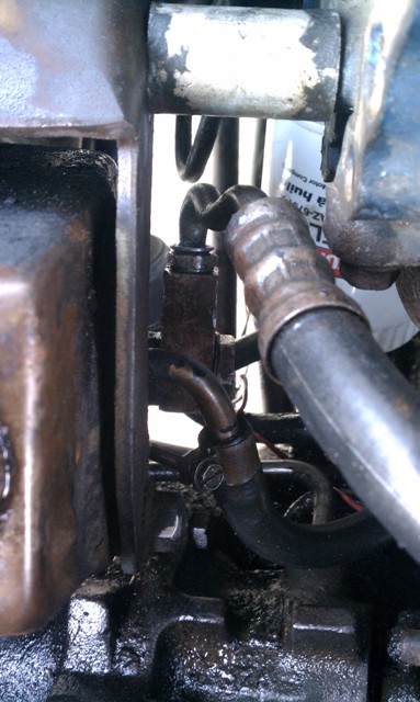1978 Ford Bronco - Detail shot of engine plumbing and components, with a filter visible in the background.