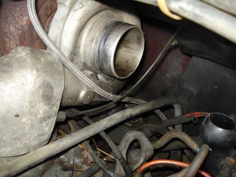 1989 Ford F-250 - A close-up view of engine components, including a turbocharger and various hoses and pipes.