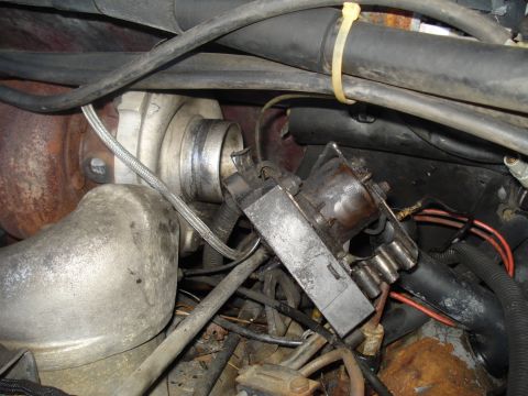 1989 Ford F-250 - Close-up view of engine components, including a turbocharger and various hoses and wires.