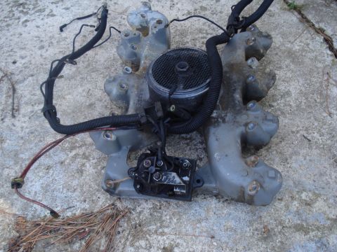 1989 Ford F-250 - Intake manifold assembly with wiring, likely removed from a vehicle for repair or replacement.