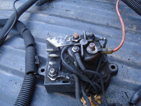 1989 Ford F-250 - Close-up of a starter solenoid with associated electrical wiring, possibly removed from a vehicle.