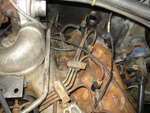 1989 Ford F-250 - Engine compartment detail with fuel lines and various hoses visible.