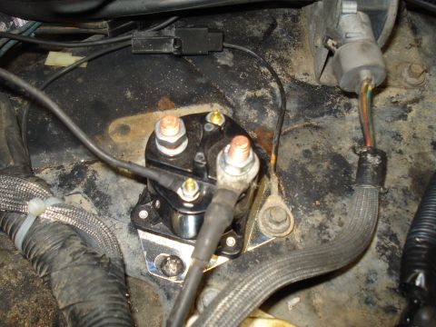 1989 Ford F-250 - Close-up view of a vehicle's starter solenoid and associated wiring harness in the engine bay.