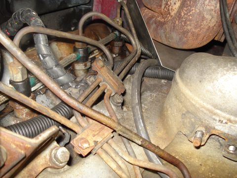 1989 Ford F-250 - Rusty fuel lines and engine parts are visible in this close-up view.