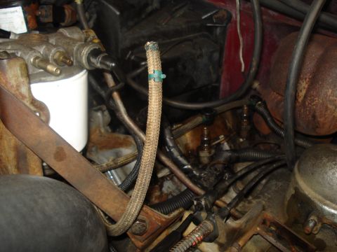 1989 Ford F-250 - Close-up view of engine bay components including a fuel filter and hoses.