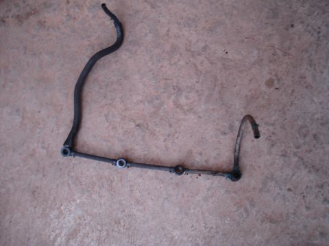 1989 Ford F-250 - A disassembled fuel line assembly lies on a concrete surface.