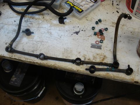 1989 Ford F-250 - Close-up of a disassembled fuel rail and associated lines, likely for engine repair.