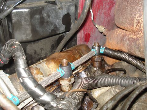 1989 Ford F-250 - Close-up view of engine components, including fuel lines and a wiring harness.