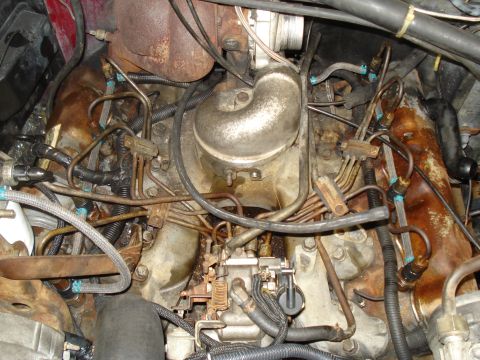 1989 Ford F-250 - A detailed view of various engine components, including fuel lines and a turbocharger, within a vehicle.