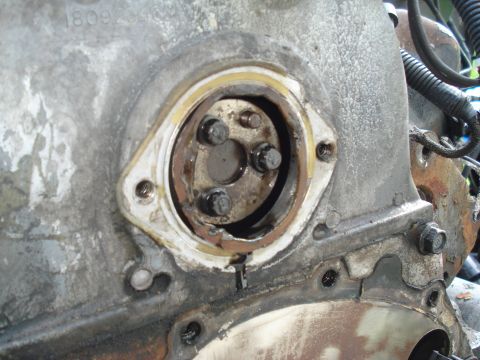 1989 Ford F-250 - Detail of an engine's timing cover seal area, showing bolts and gasket material.