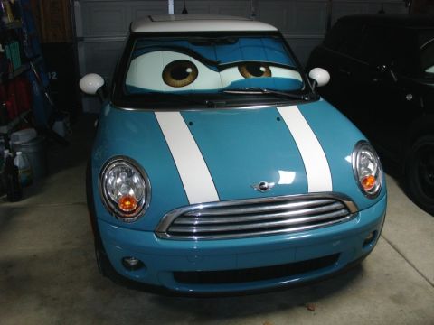 2010 MINI Cooper - A blue MINI Cooper is parked in a garage with a sunshade that gives it cartoon eyes.