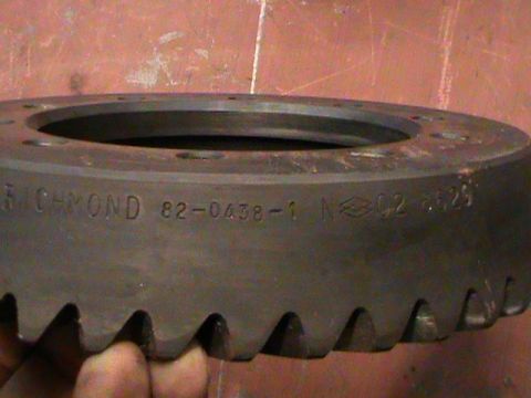 1995 Ford Bronco - A close-up view of a ring gear shows stamped part numbers and manufacturing codes.