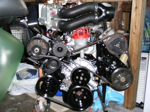 1996 Ford Bronco - A detailed view of a clean engine assembly, black hoses and a red distributor cap.