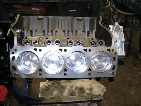 1996 Ford Bronco - Engine block with pistons installed, part number visible on the block.