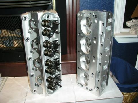 1996 Ford Bronco - Pair of aftermarket aluminum engine cylinder heads shown indoors.