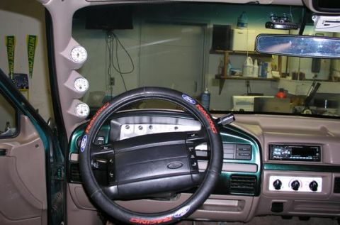 1996 Ford Bronco - The interior of a 1996 Ford Bronco shows aftermarket gauges and a steering wheel cover.