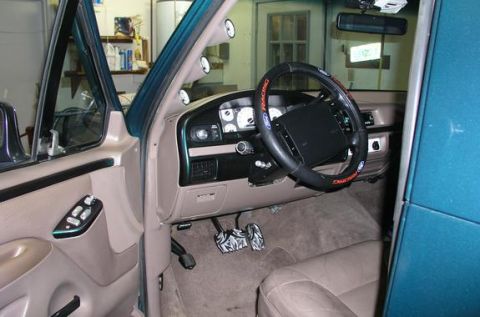 1996 Ford Bronco - Interior view of a 1996 Ford Bronco, aftermarket pedals and additional gauges on the A-pillar.