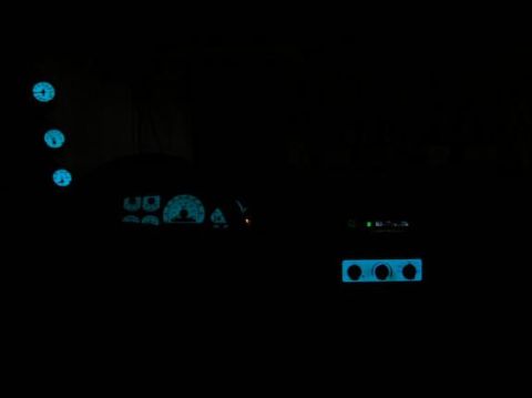 1996 Ford Bronco - Interior view of a car at night with illuminated dashboard gauges and controls.