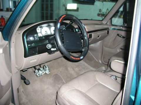 1996 Ford Bronco - Interior view of a 1996 Ford Bronco, showing the dashboard, steering wheel, and tan leather seats.