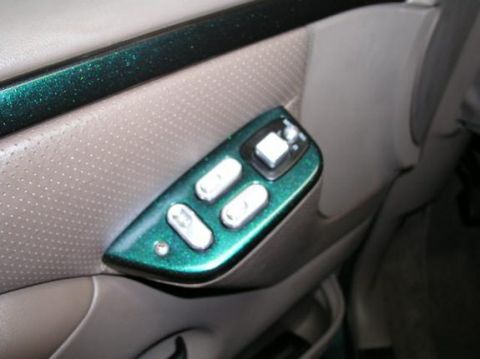 1996 Ford Bronco - Interior door panel with power window controls, painted green with metallic flakes.