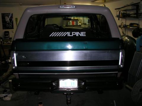1996 Ford Bronco - Rear view of a Ford Bronco with a two-tone paint job and an aftermarket sticker on the back window.