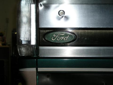 1996 Ford Bronco - Close-up of the rear of a 1996 Ford Bronco, showing the Ford emblem and a vertical taillight.