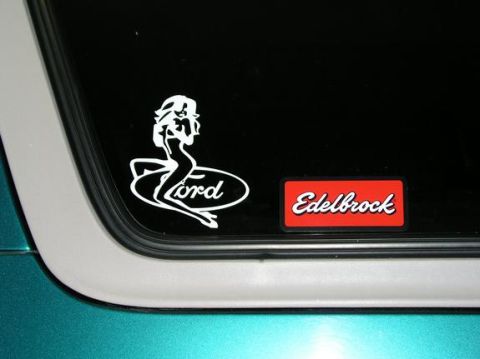 1996 Ford Bronco - A close-up shows a Ford logo sticker with a pin-up girl and an Edelbrock sticker on a vehicle's window.