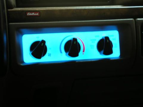 1996 Ford Bronco - Close-up of the illuminated climate control knobs in a vehicle's dashboard.