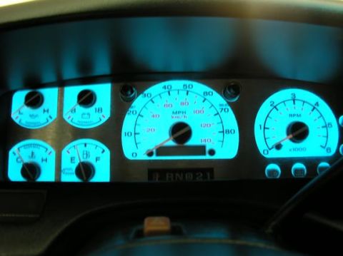 1996 Ford Bronco - The illuminated dashboard gauges of a 1996 Ford Bronco, showing speedometer, tachometer, fuel, and temperature readings.