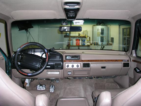 Interior of a 1996 Ford Bronco showing the dashboard, steering wheel, and seats