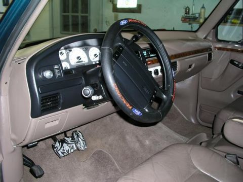 1996 Ford Bronco - The interior of a 1996 Ford Bronco, showing the dashboard, steering wheel, and pedals.