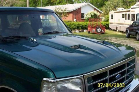 1996 Ford Bronco - This 1996 Ford Bronco features a prominent hood scoop and '5.8' badging, seen here in a three-quarter front view.
